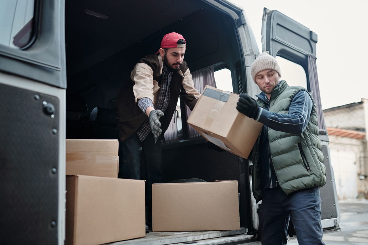 Lakvi team carefully unloading boxes from the vehicle